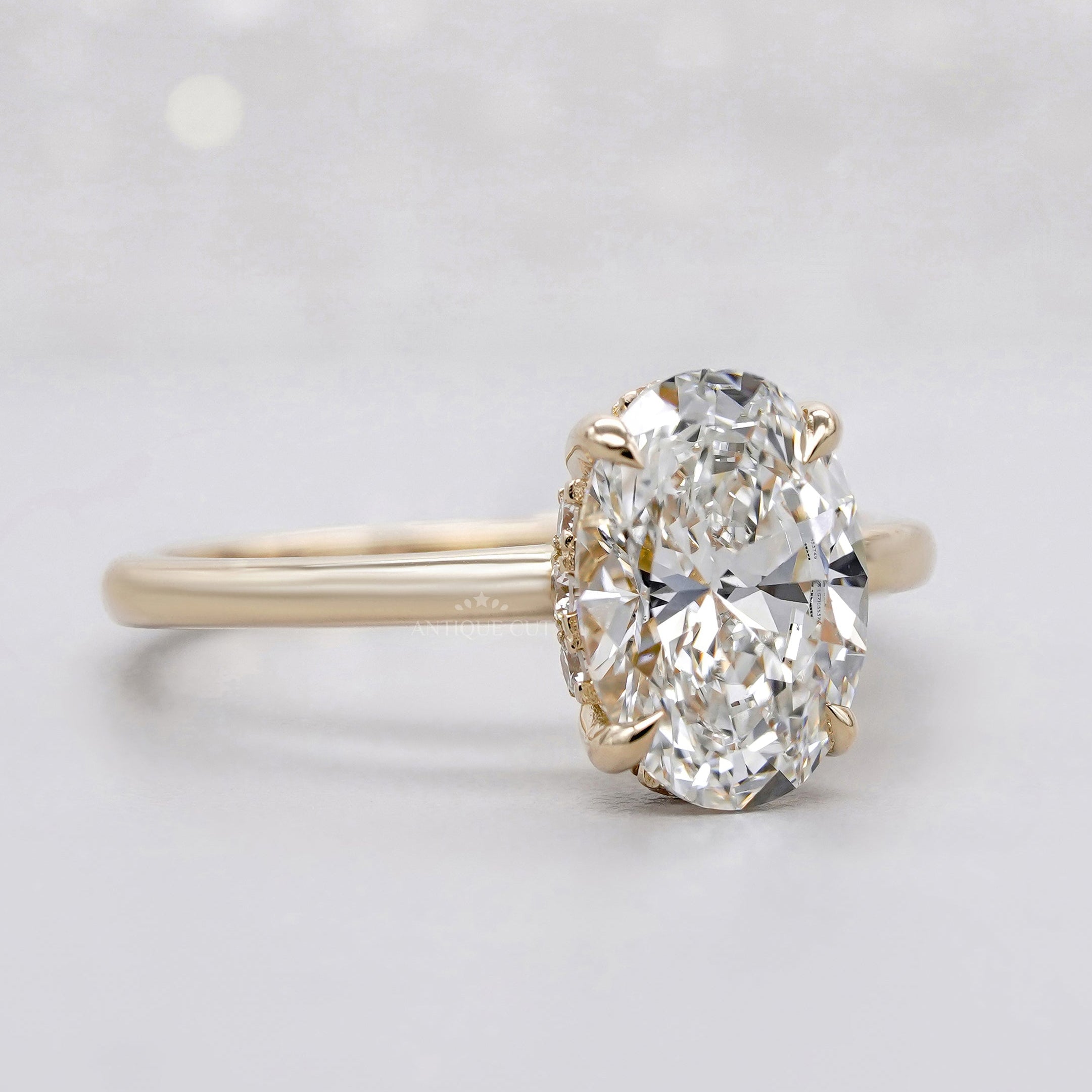 Yellow gold oval engagement ring with hidden halo