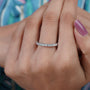 Silver ring with diamonds on a soft blue background

