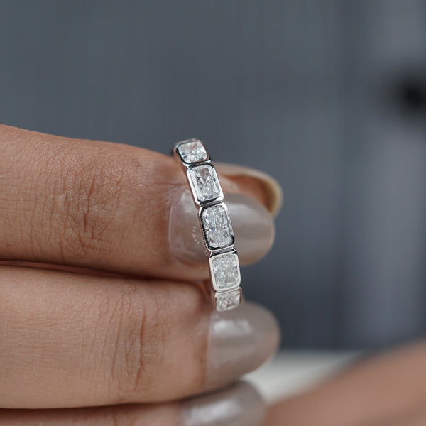 Radiant cut diamond wedding band on hand