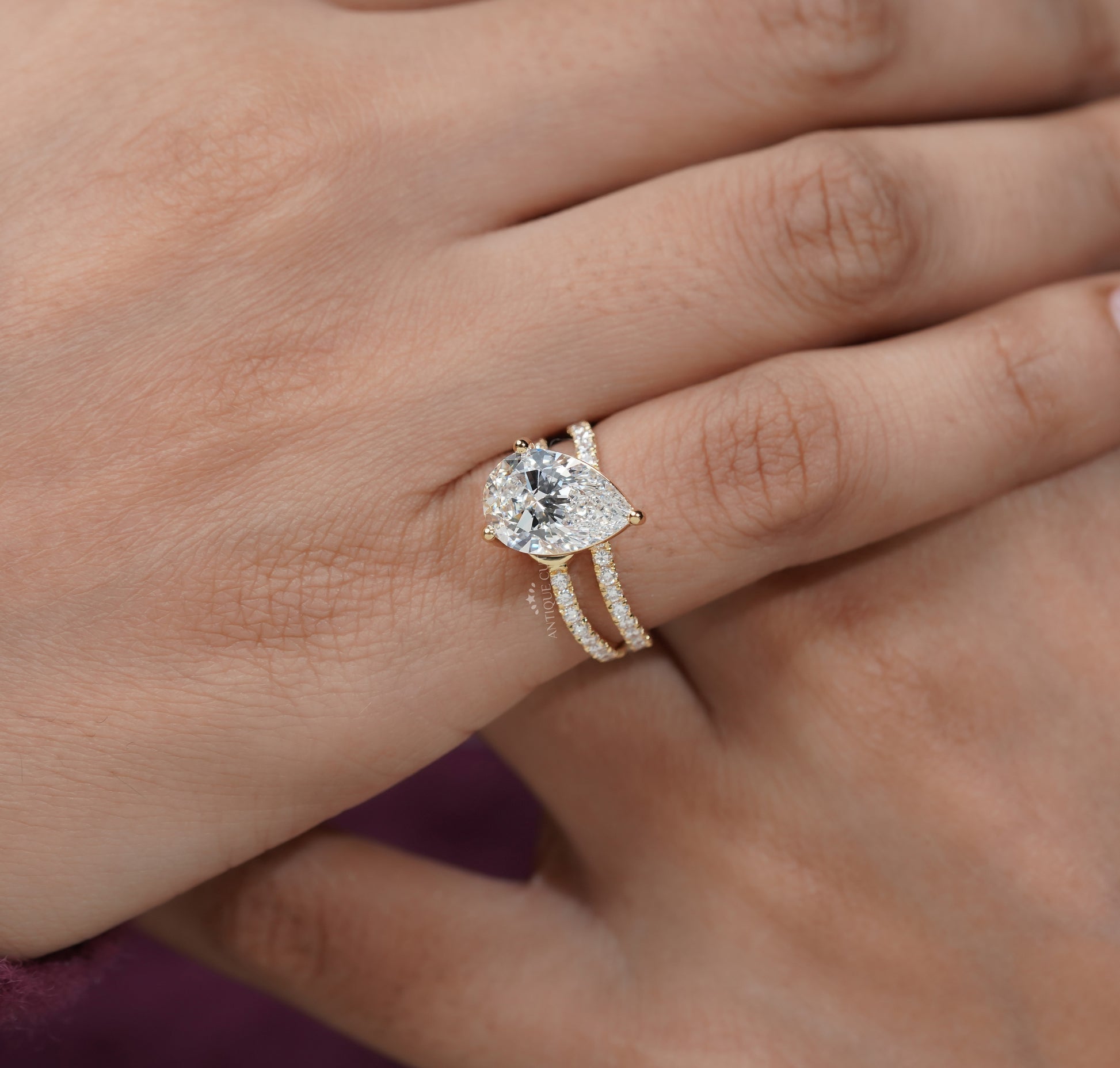 Pear diamond engagement ring with pave side stone details