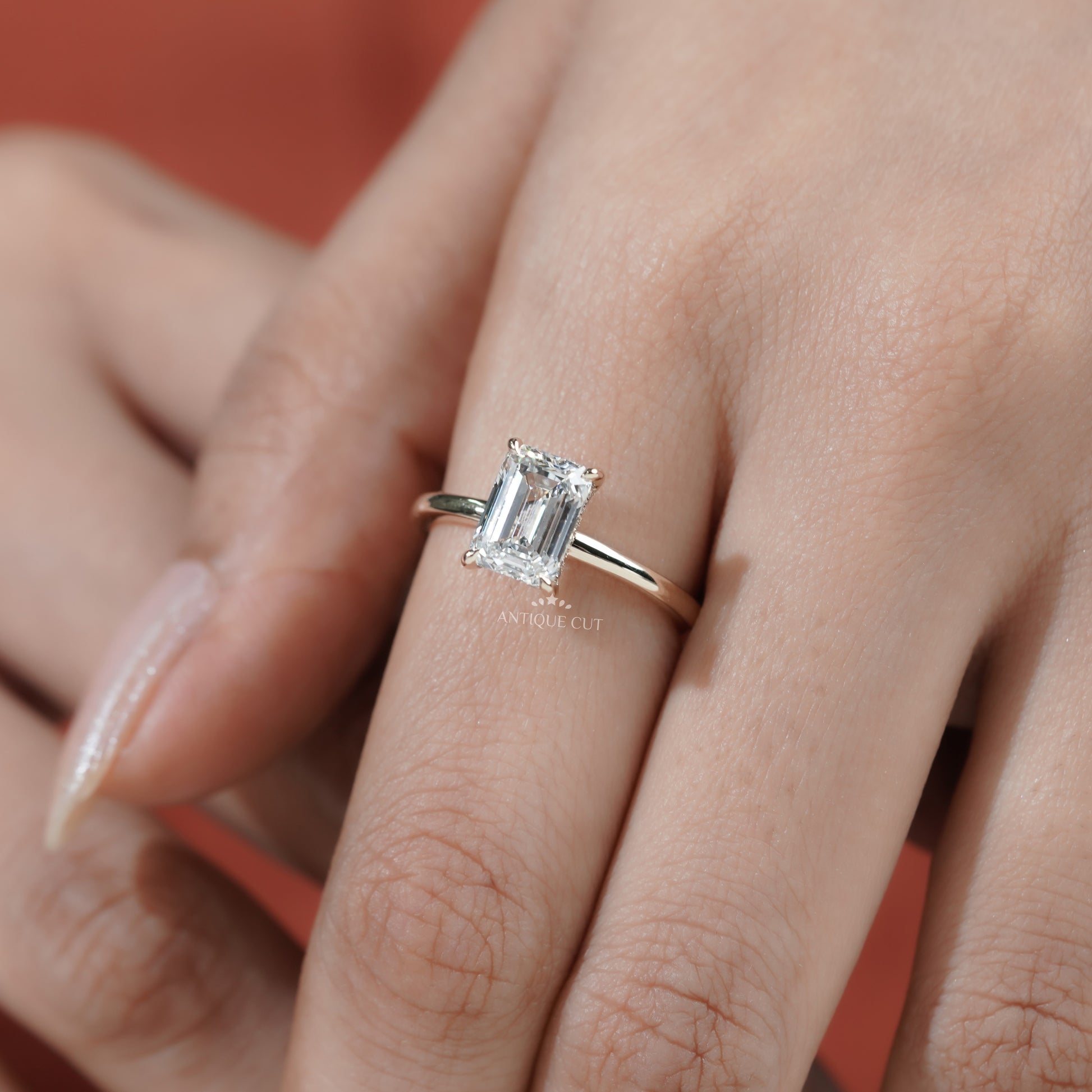 Yellow gold emerald diamond engagement ring with halo detail