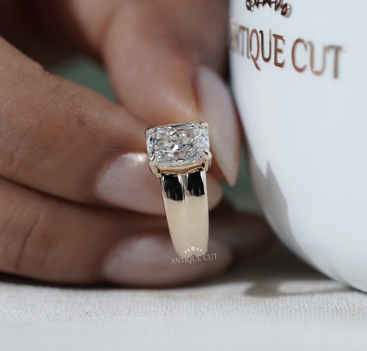 Yellow gold engagement ring with radiant diamond center and four prong setting