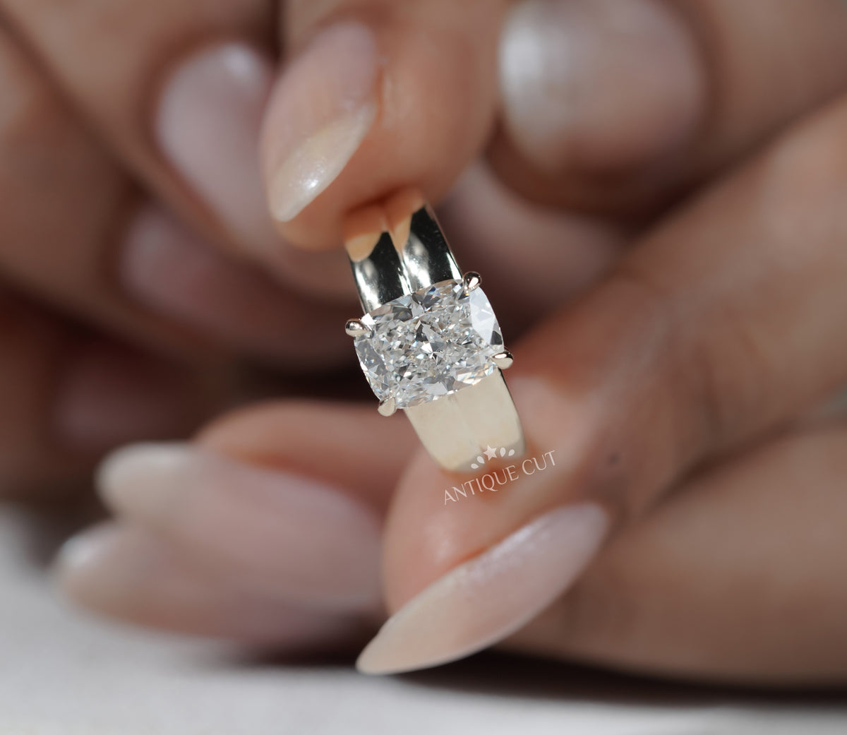 Yellow gold solitaire ring with rectangular radiant cut diamond center stone
