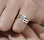 Wide band yellow gold engagement ring with radiant cut center diamond