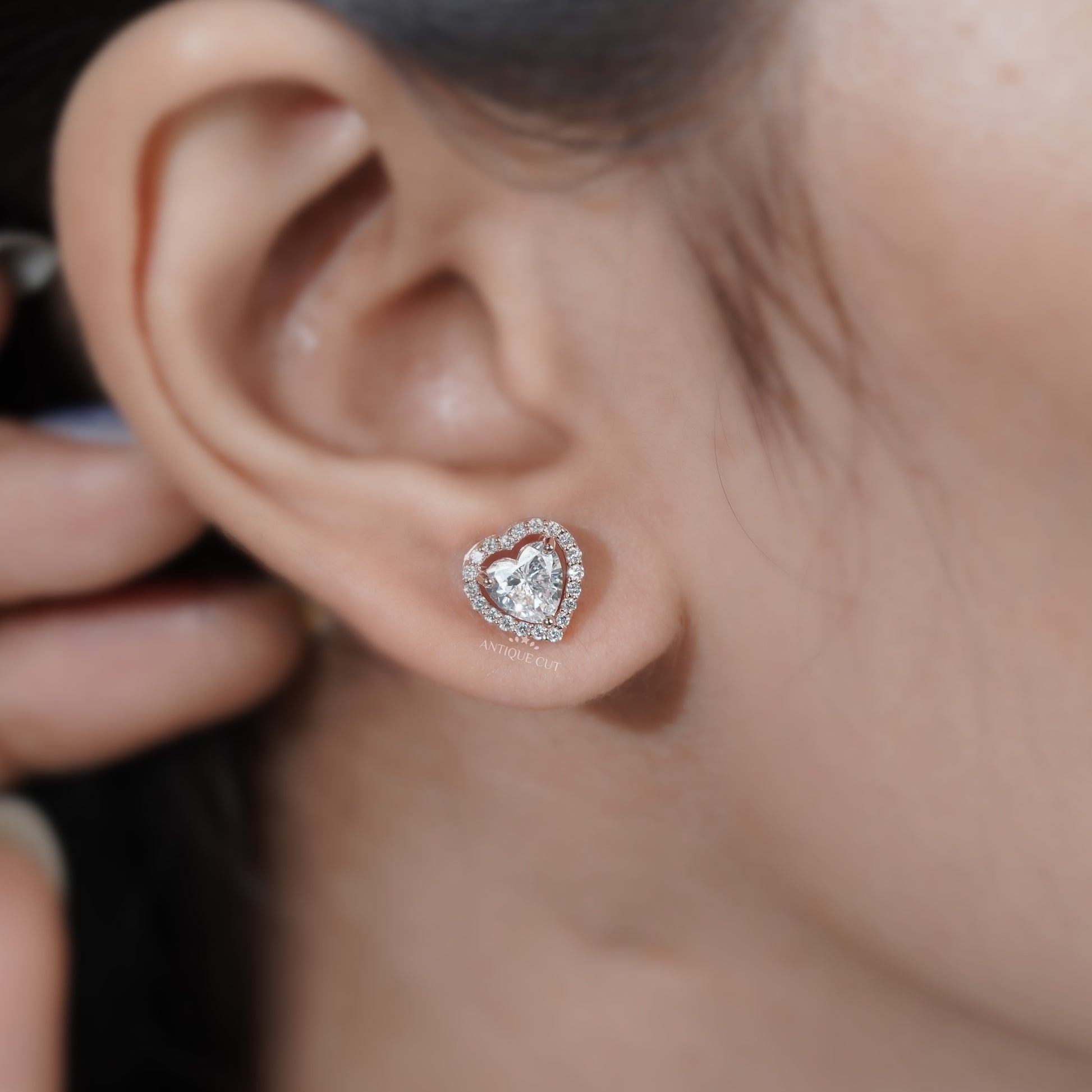 Heart shaped solitaire diamond earrings with halo accents
