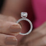 Elegant oval solitaire ring with hidden halo and diamond band