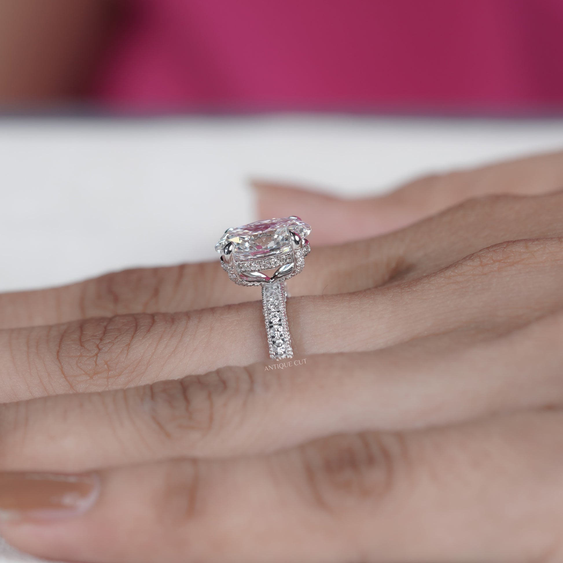 Close up of oval cut engagement ring with pavé diamond band