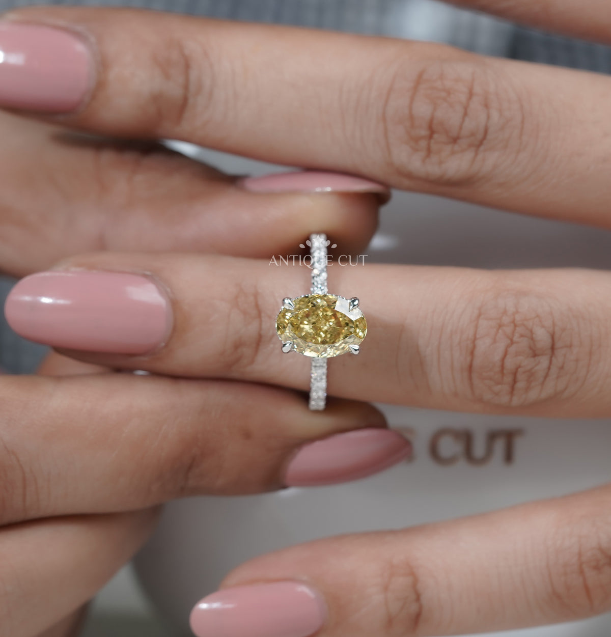 Hidden halo ring with an oval yellow diamond