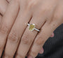Oval yellow center stone ring with diamond accents