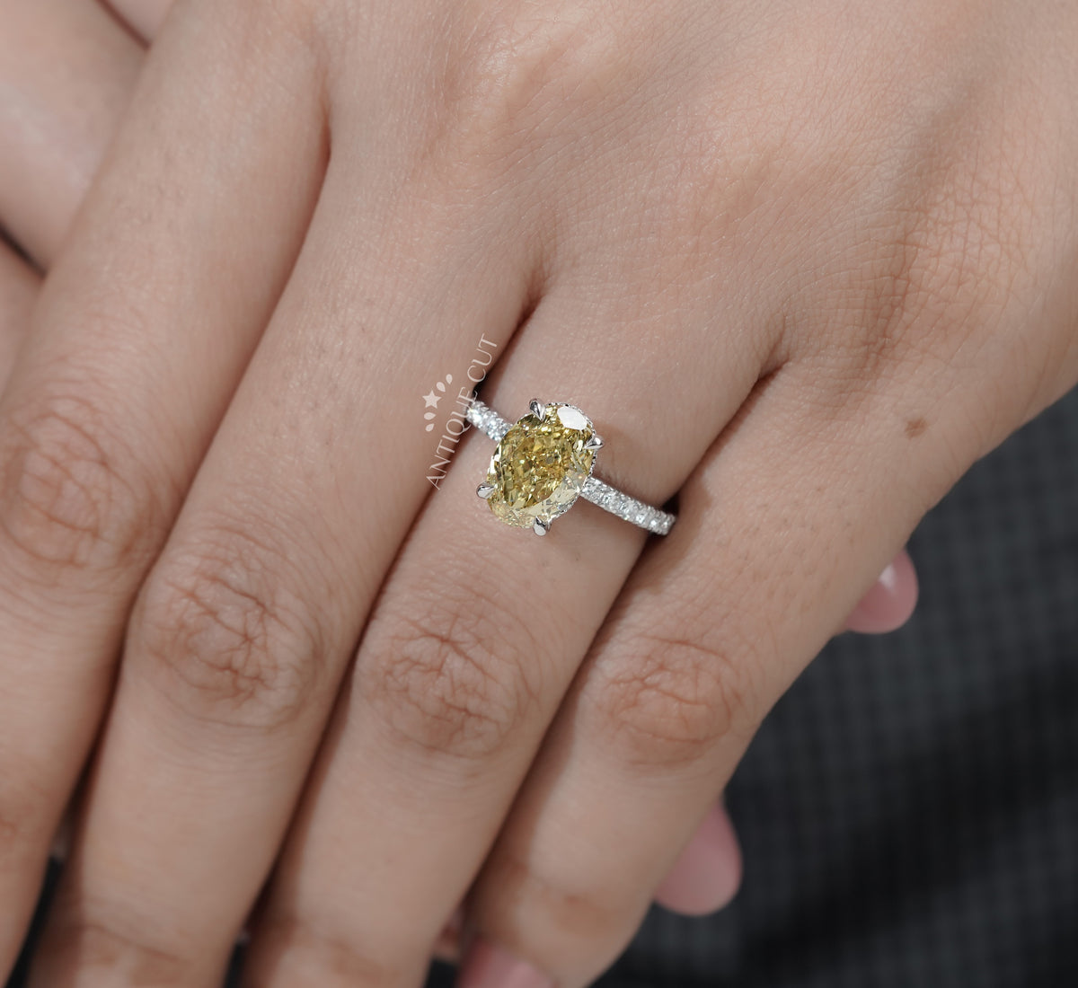 Oval yellow center stone ring with diamond accents