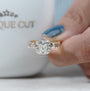 Contemporary cushion cut engagement ring with horizontal setting