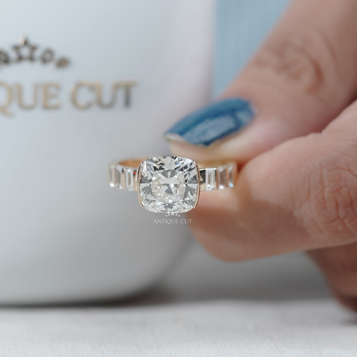 Contemporary cushion cut engagement ring with horizontal setting