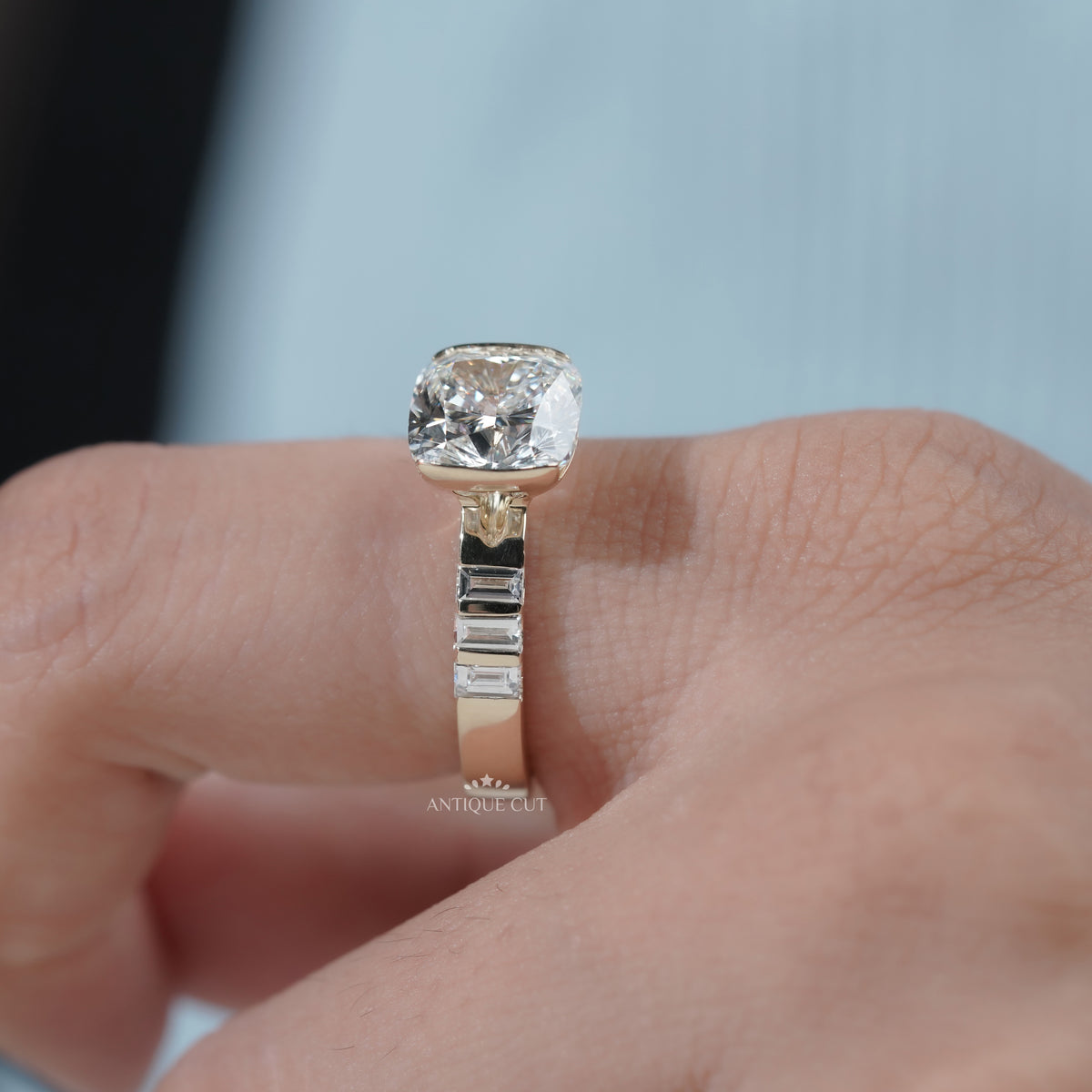 Close up of cushion cut diamond half bezel engagement ring