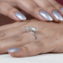 Emerald cut diamond with pear side stone engagement ring