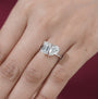 White gold two stone engagement ring with emerald and pear diamonds