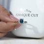 Emerald solitaire style blue diamond ring white gold