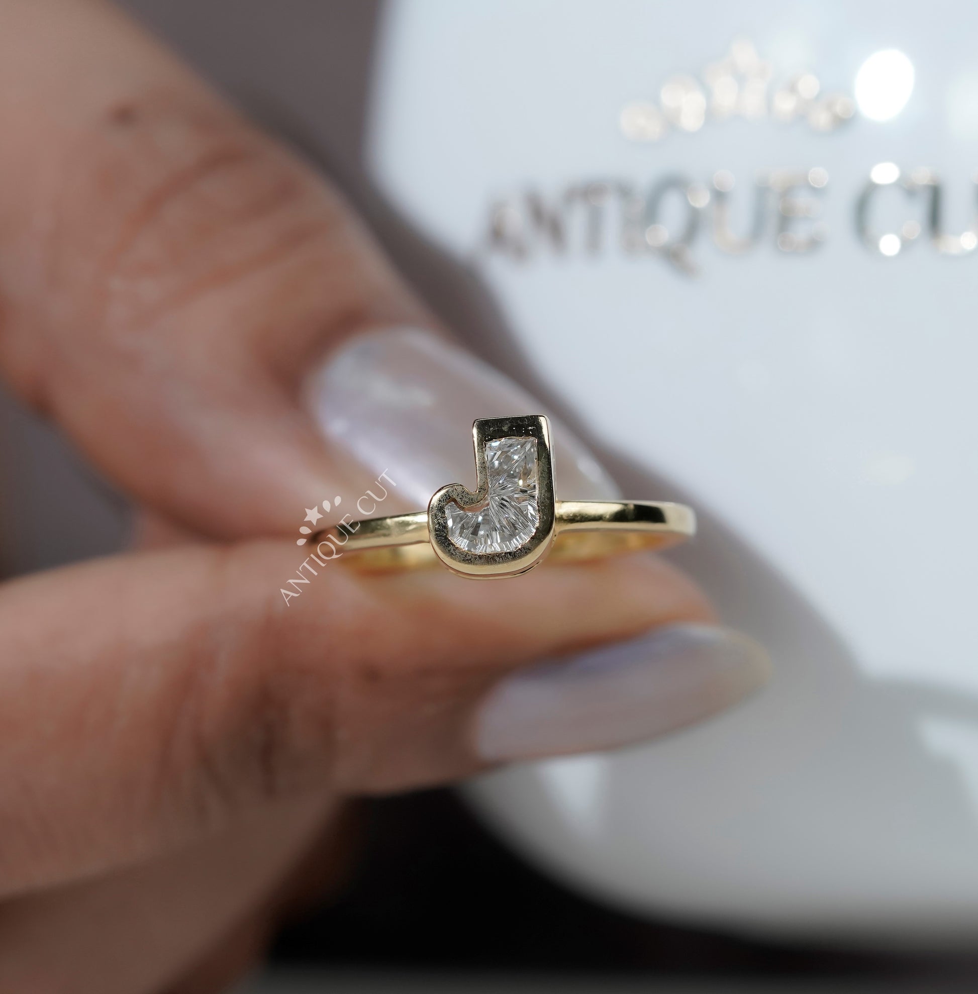 J letter lab grown diamond ring with bezel setting and yellow gold band