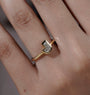 Yellow gold J letter engagement ring featuring a bezel set lab grown diamond