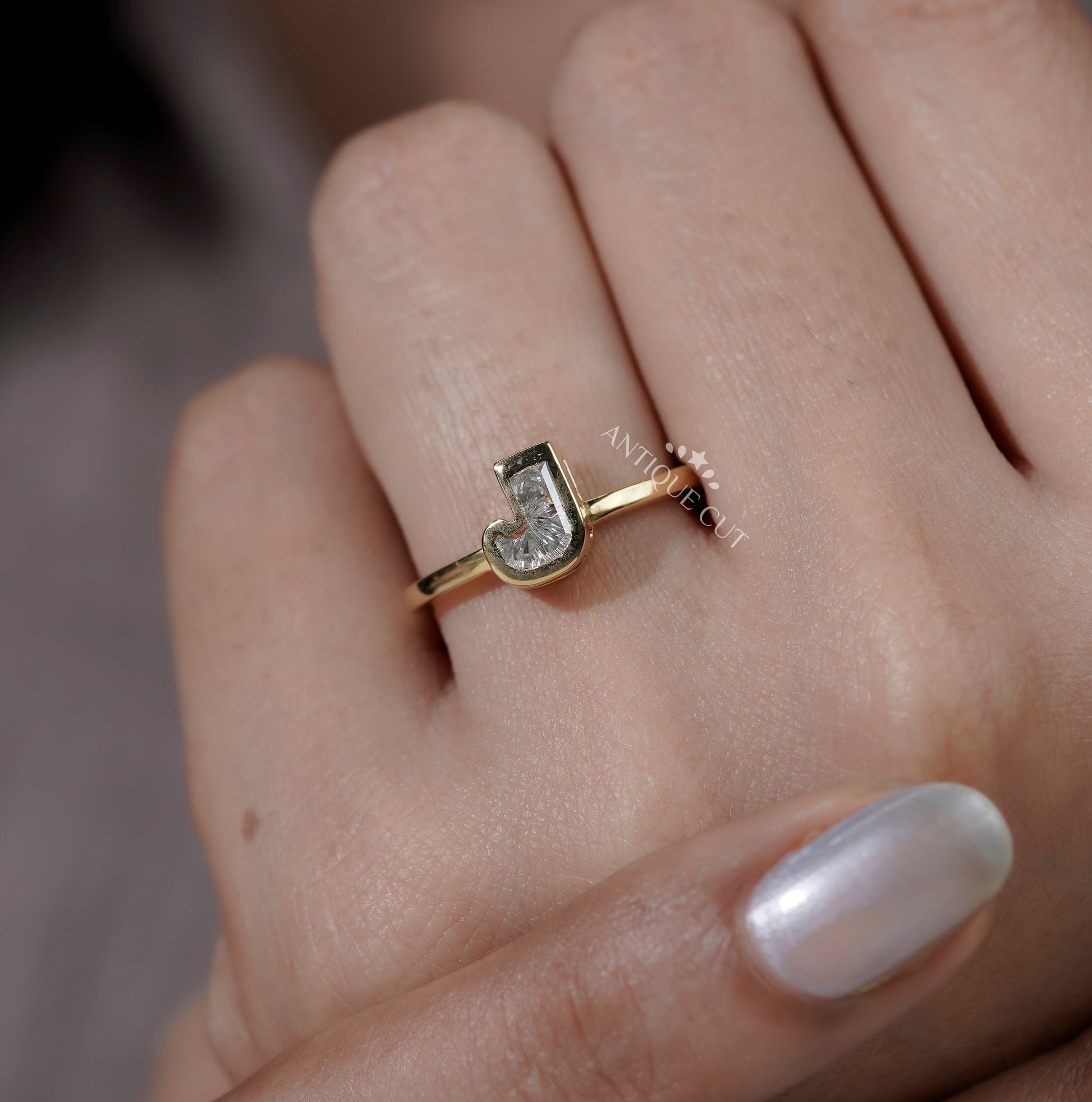 Yellow gold J letter ring featuring an IGI certified lab grown diamond