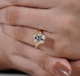 Yellow gold radiant diamond ring with sculpted cathedral shoulders
