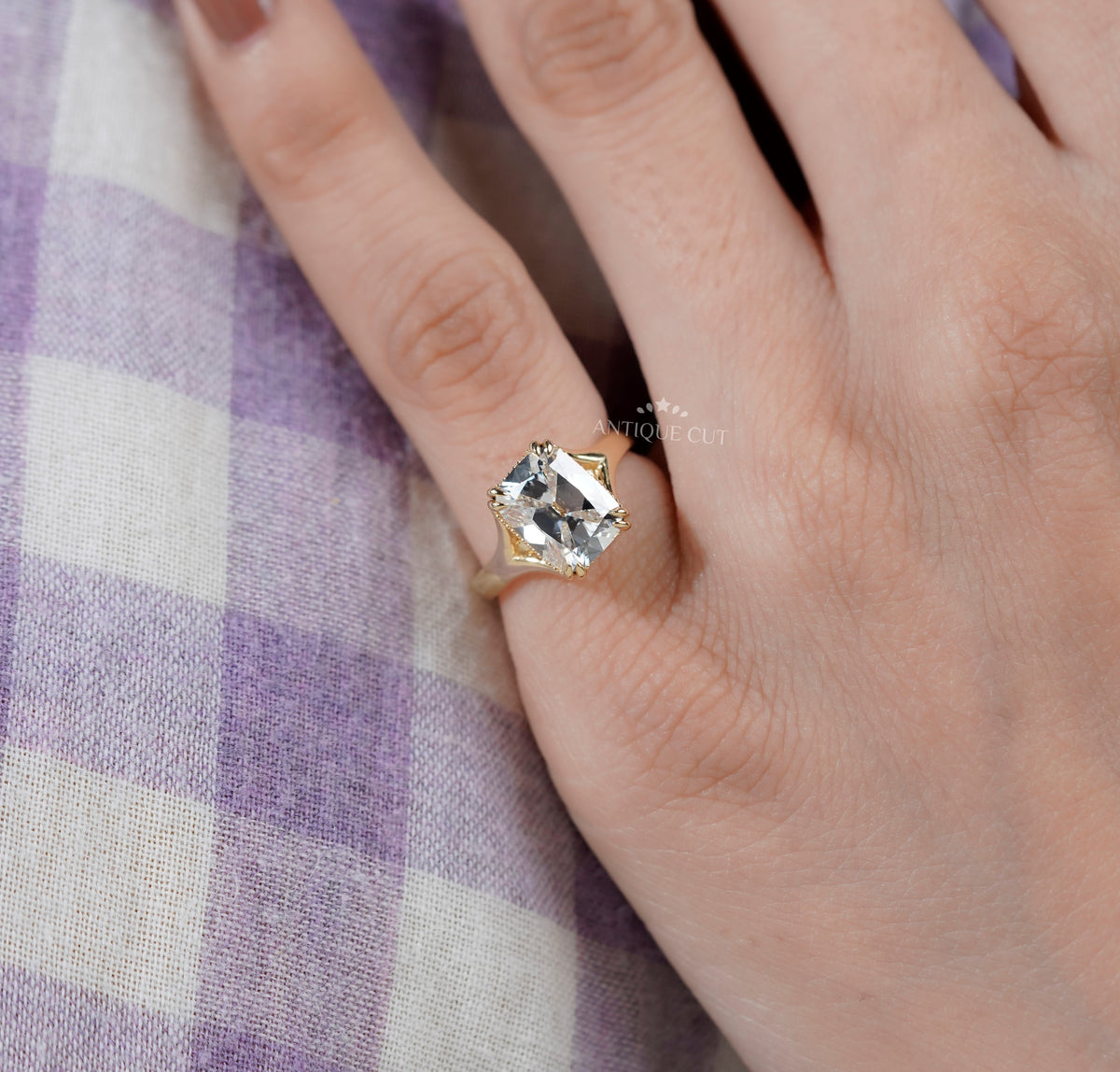 cushion cut diamond engagement ring with double-prong setting.