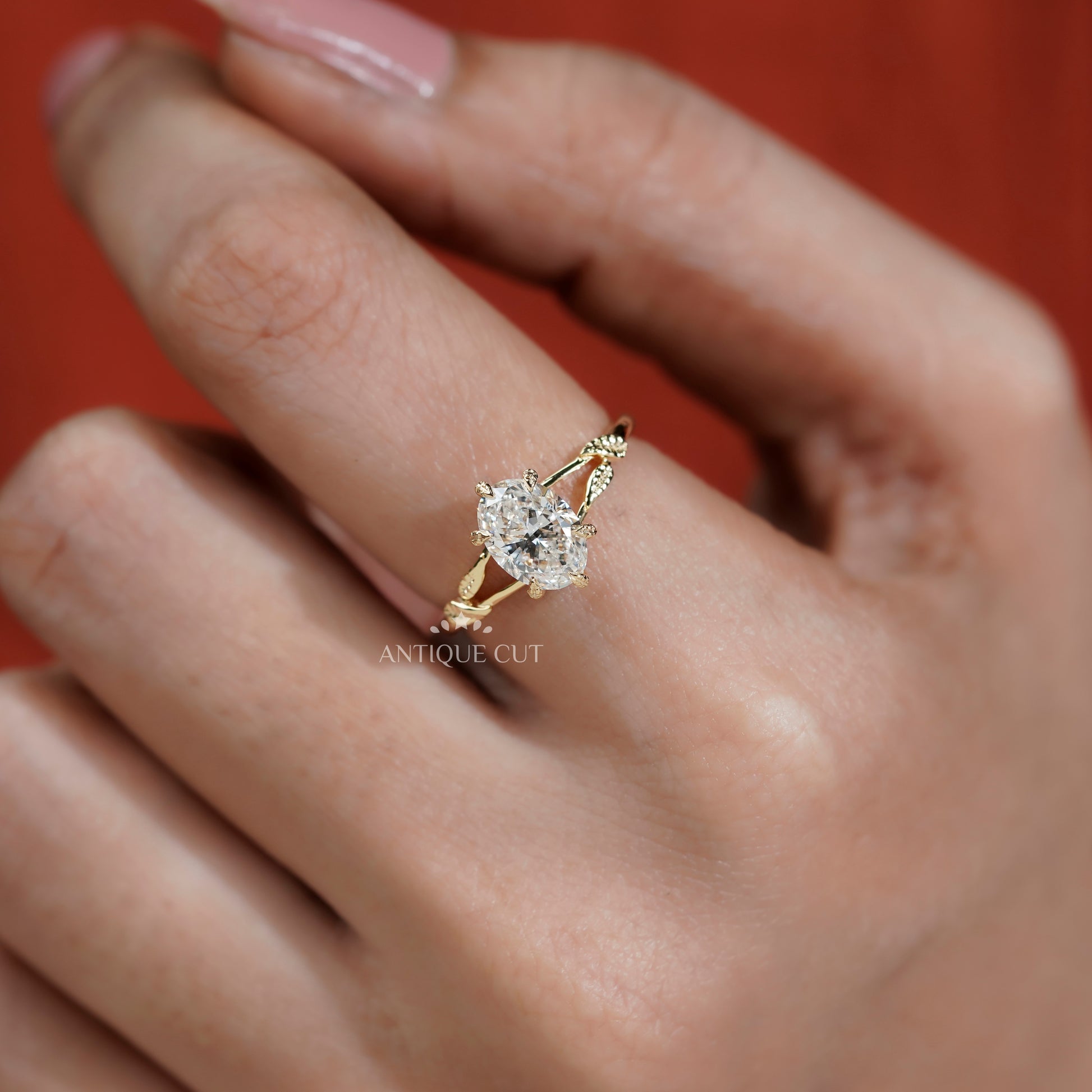 Oval diamond solitaire ring with vintage floral leaf details