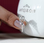 Round brilliant diamond ring with delicate side stones