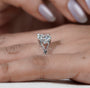 Round cut solitaire ring with decorative white gold shoulders