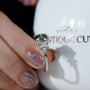 Elegant round cut green diamond ring with side stones