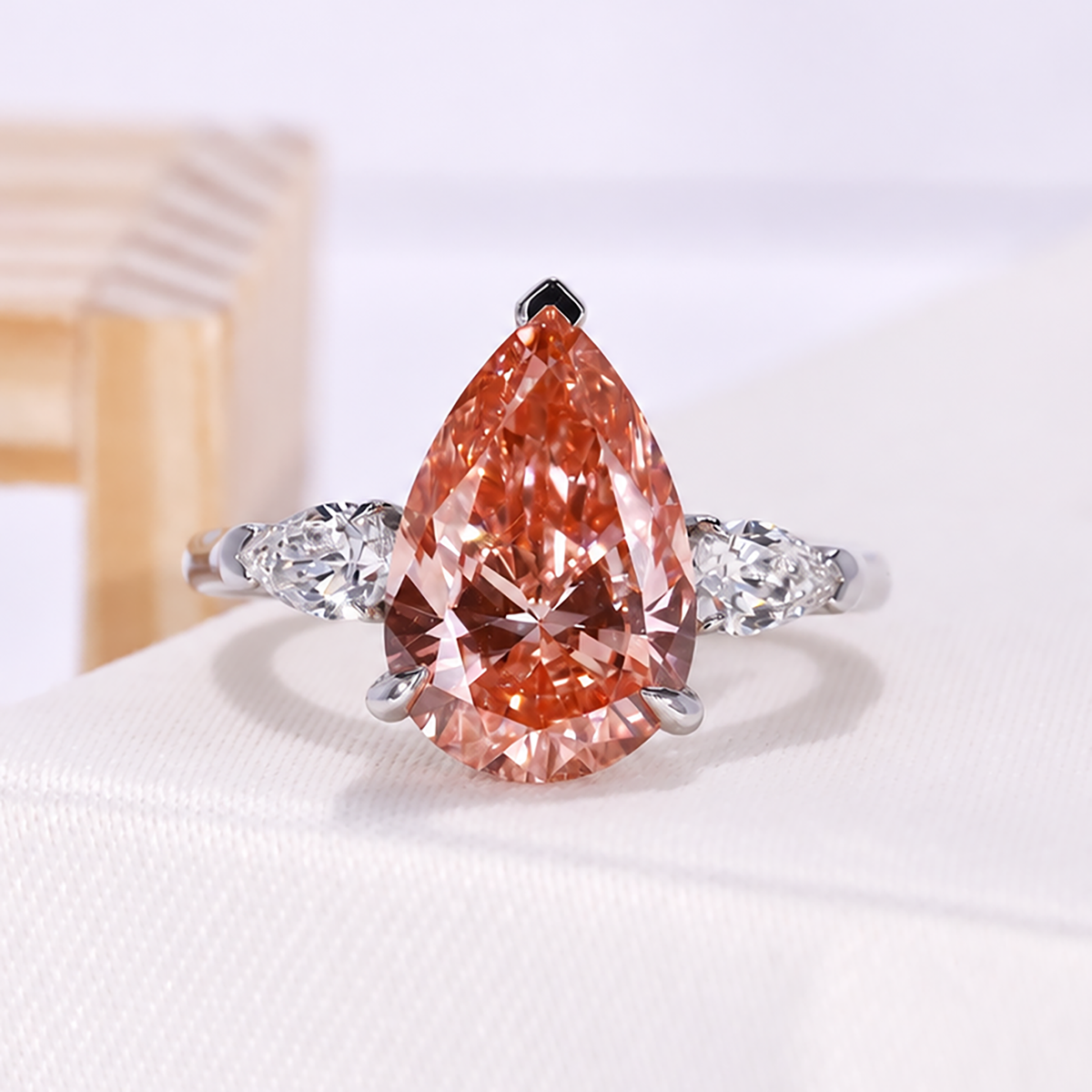 Fancy pink pear lab grown diamond ring with three stone engagement ring design