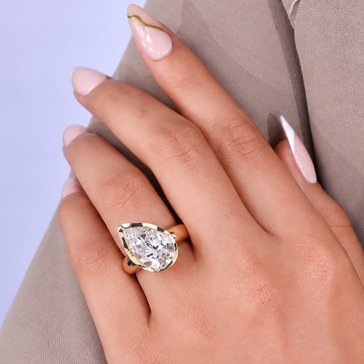 Minimal bezel setting engagement ring with pear lab grown diamond center