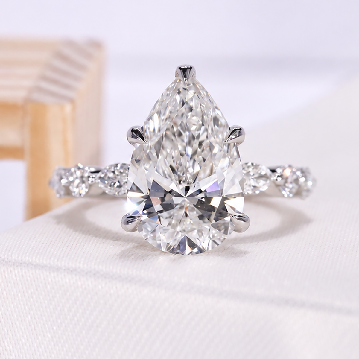 5.00 carat pear lab grown diamond ring with bezel setting in yellow gold