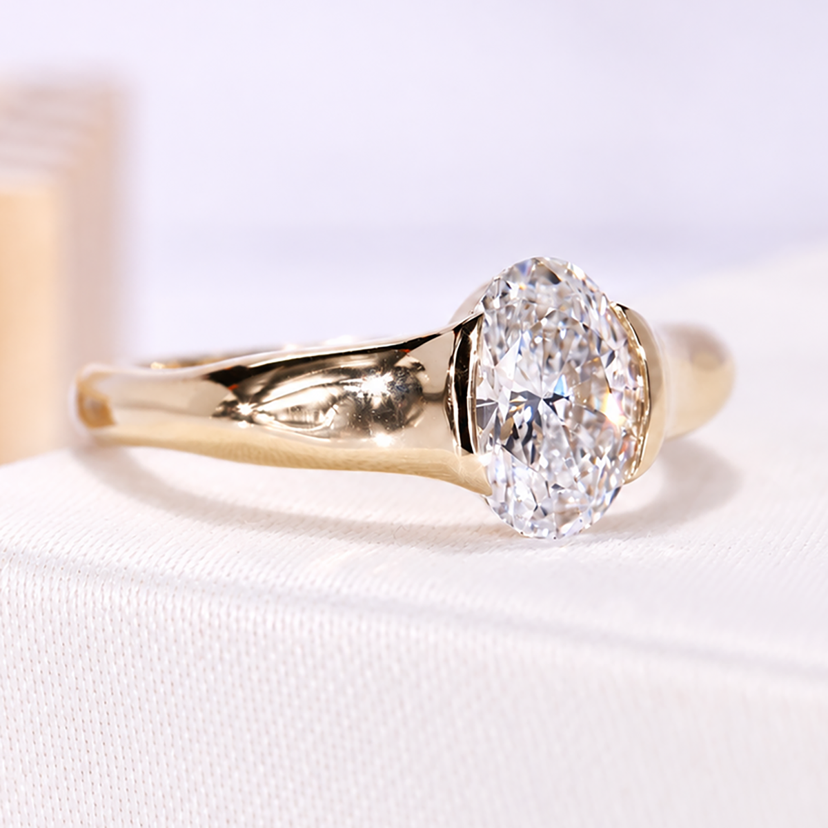 Yellow gold half bezel oval solitaire engagement ring with lab grown diamond