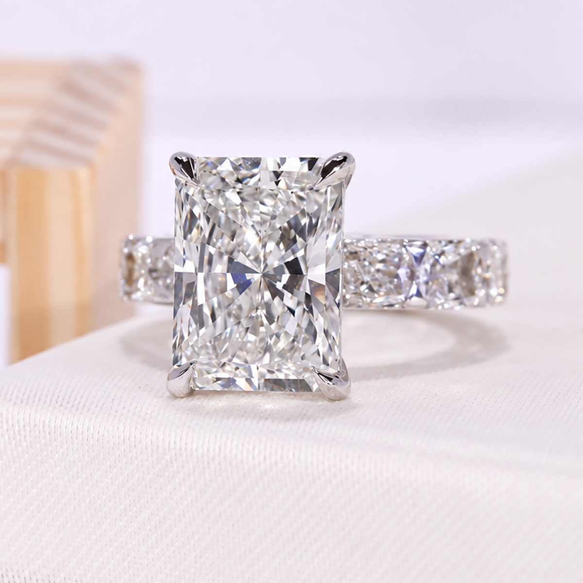 Lab grown diamond ring with radiant cut center stone and detailed side stone setting