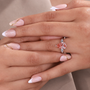 Fancy pink diamond bridal ring featuring pear cut lab grown center stone