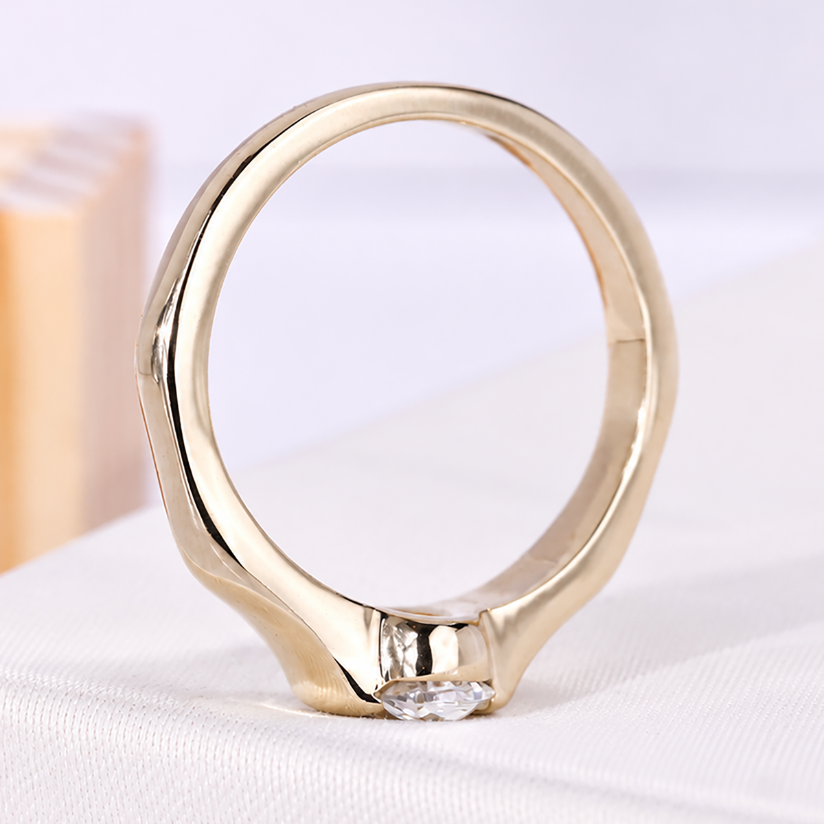 Oval center stone solitaire engagement ring with half bezel gold setting
