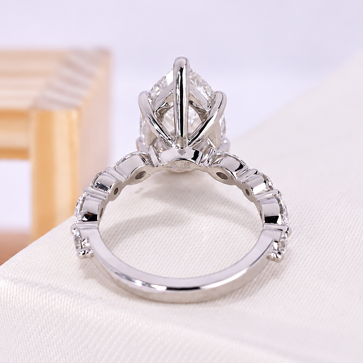 Minimal bezel setting engagement ring with pear lab grown diamond center