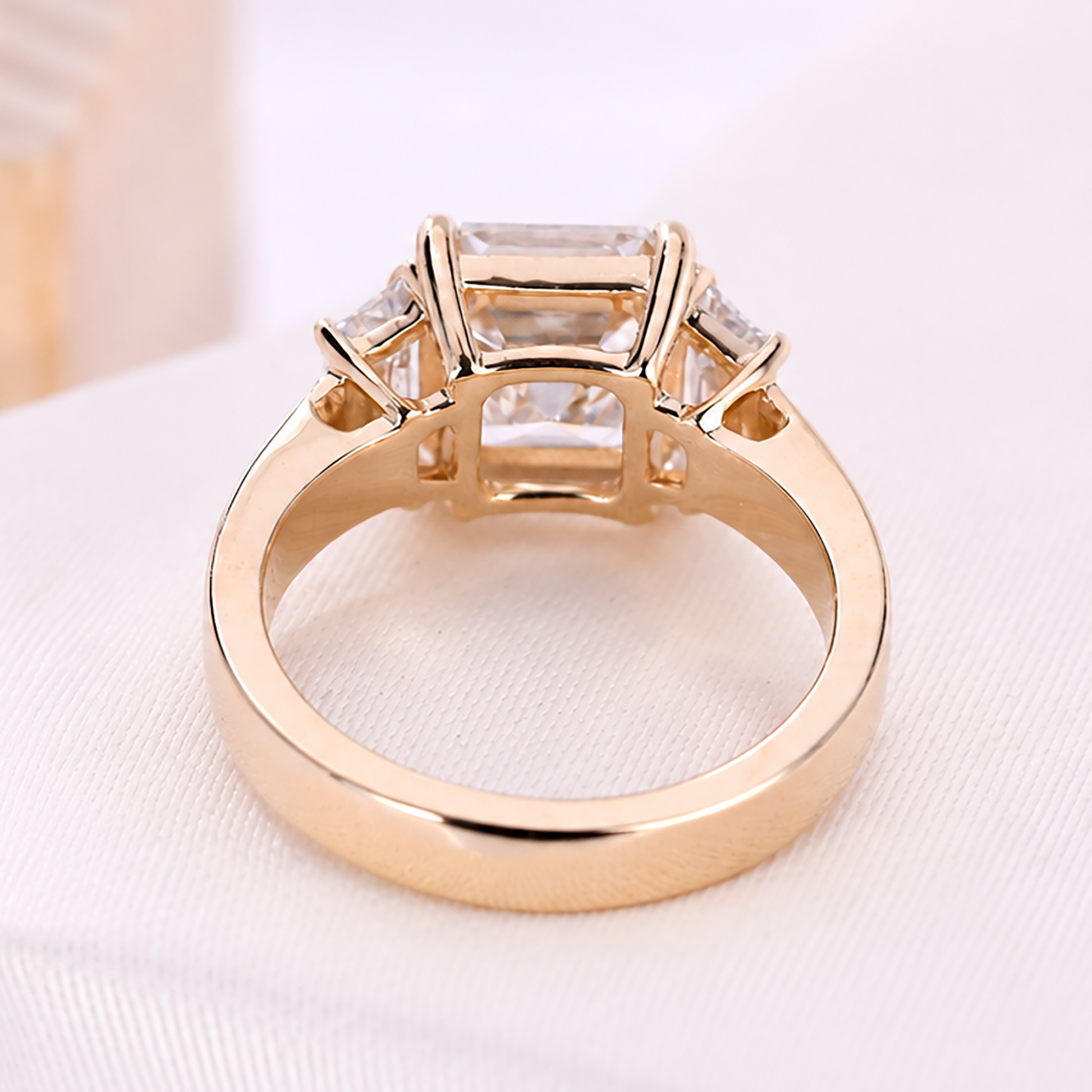 Asscher cut center diamond with two side stones