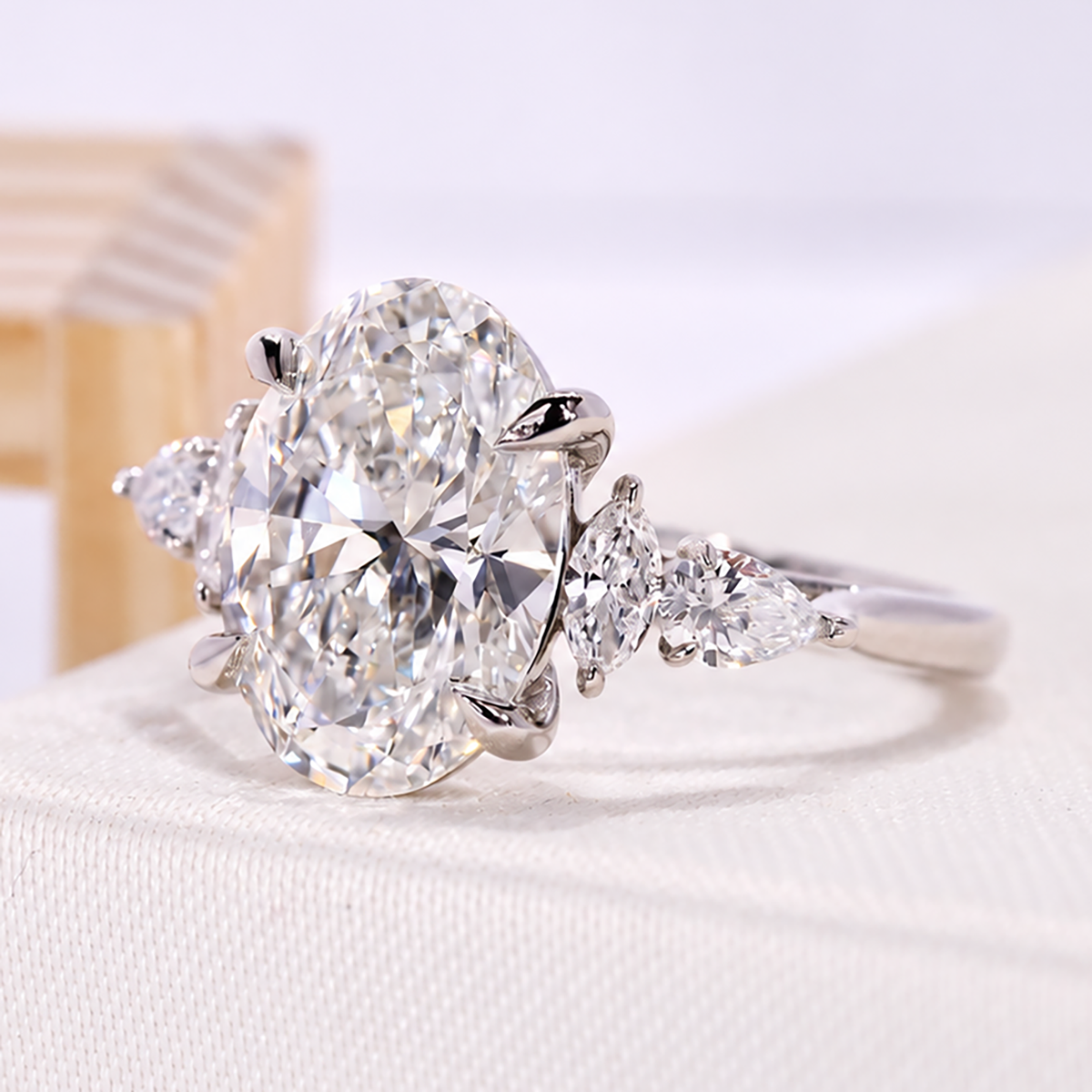 oval cut diamond ring with marquise and pear cut side stone