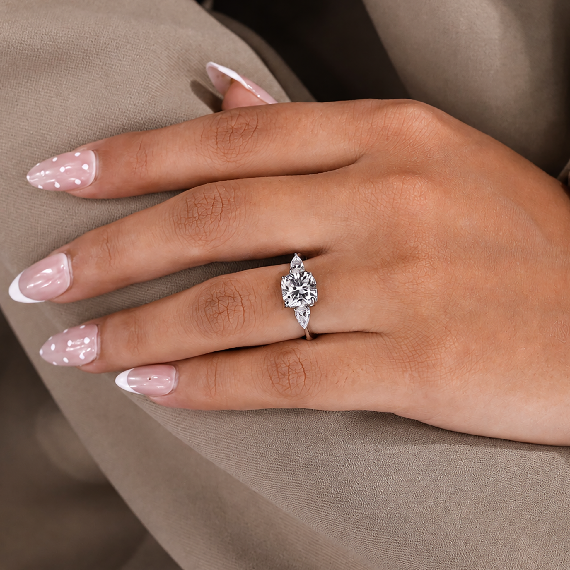 Cushion cut ring with pear cut side stone