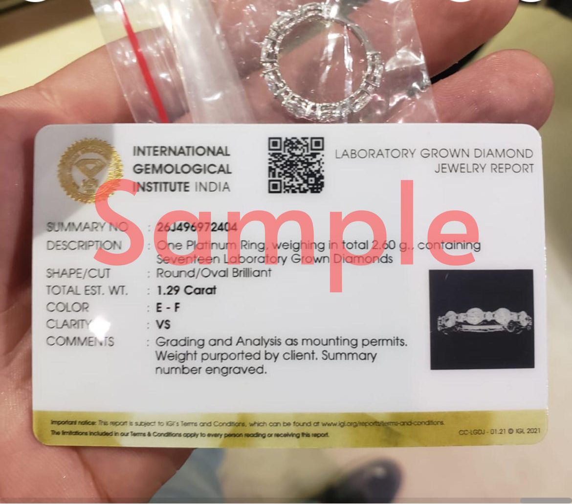 International Gemological Institute India certificate for a laboratory grown diamond platinum ring held in hand.