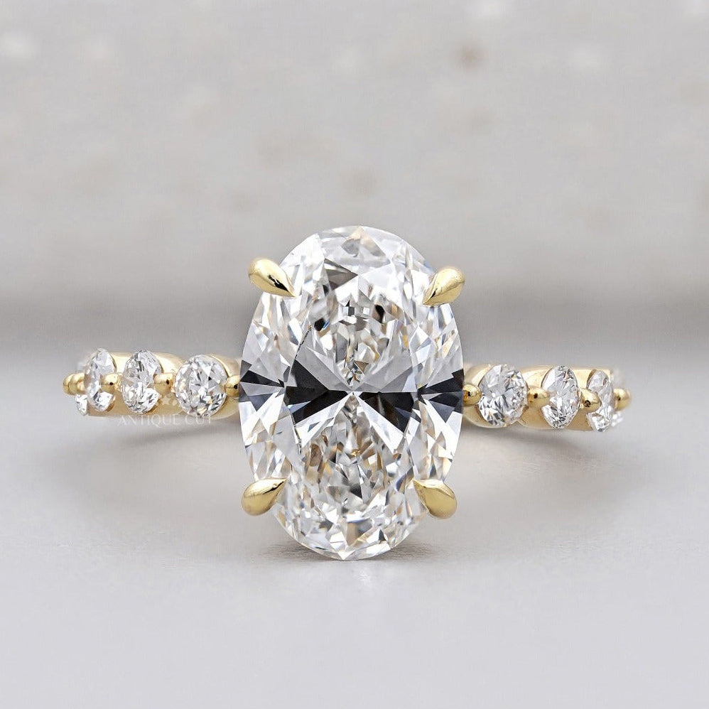 Hidden halo oval engagement ring with pave band