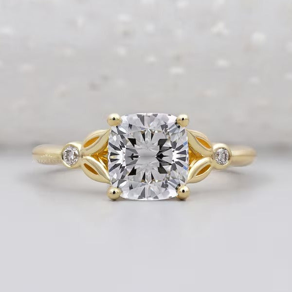 Cushion solitaire engagement ring with side stones in yellow gold