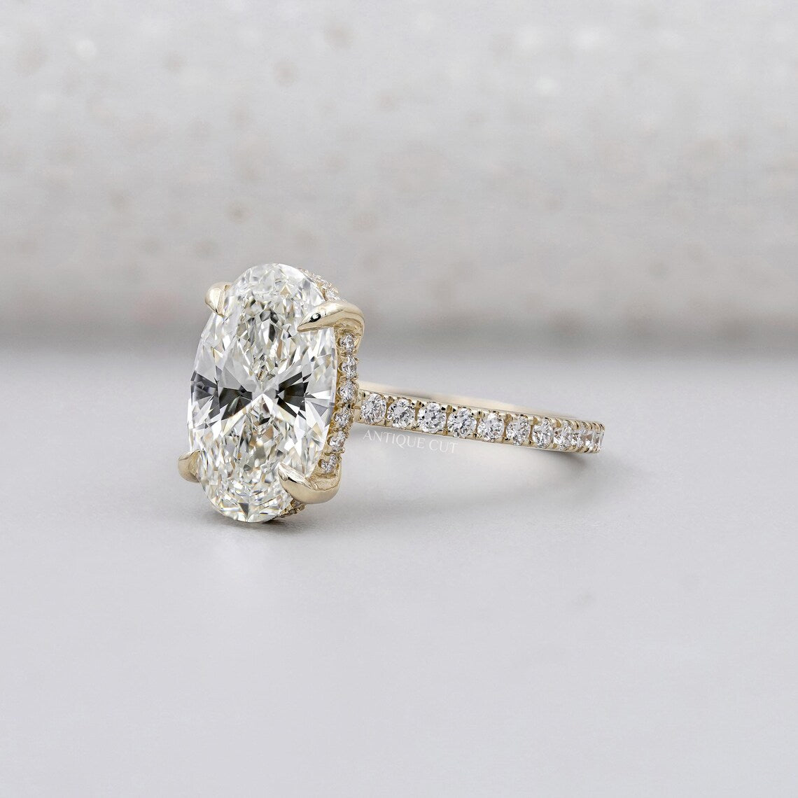 Oval cut diamond ring with hidden halo yellow gold pave