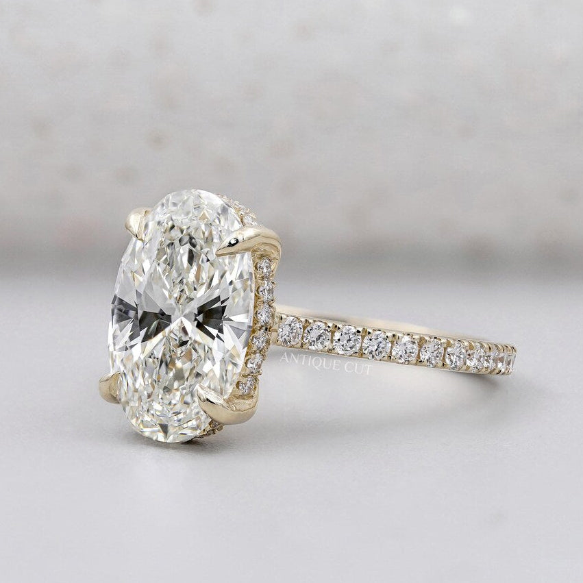 Oval cut diamond ring with hidden halo yellow gold pave