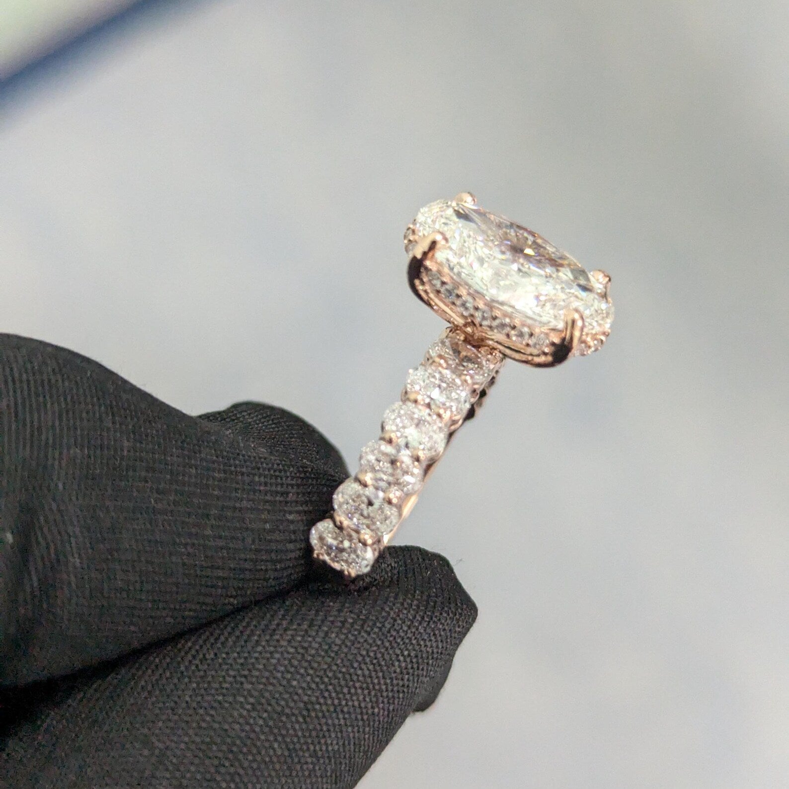 Oval center stone engagement ring with round side accents.