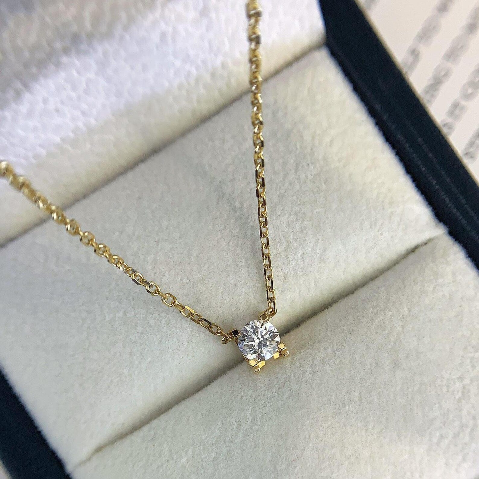 Yellow gold necklace with small solitaire diamond pendant