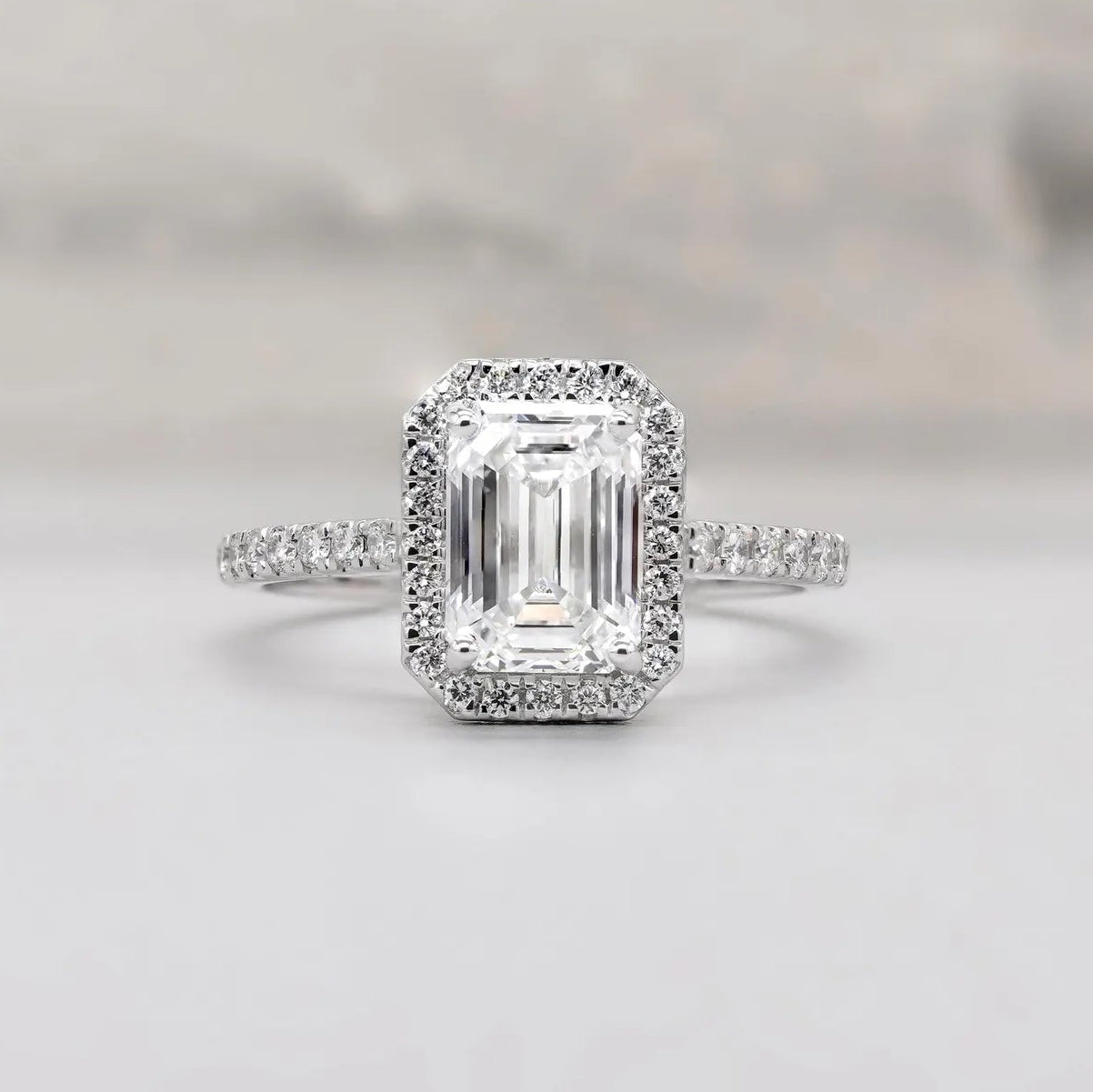 Emerald cut halo engagement ring in white gold