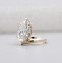Yellow gold pear shaped engagement ring with claw prongs and side diamonds