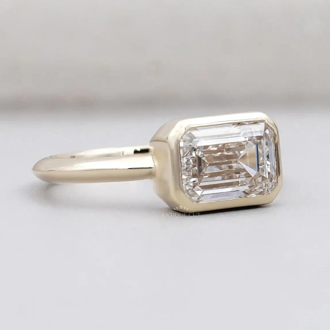 Bezel set emerald cut lab grown diamond ring